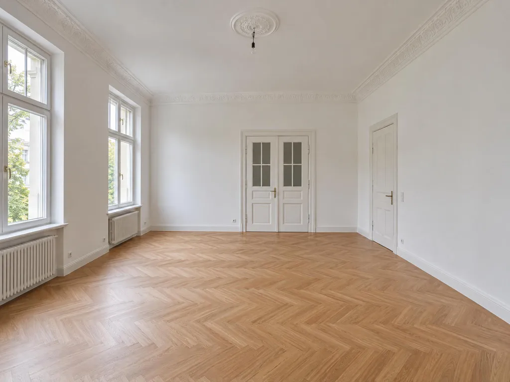 Derselbe leere Raum mit Blick gerade auf die Flügeltür, die Fenster links